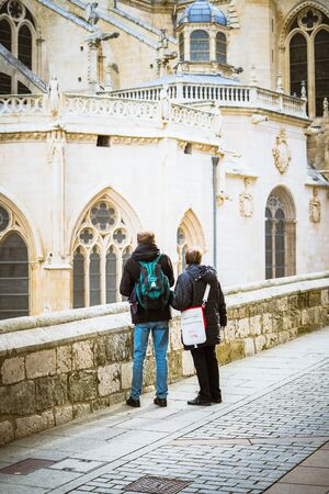 Burgos, Spain - 10.11.2016: Faceless tourists standing near cathedral. Vertical outdoor shotのeditorial素材