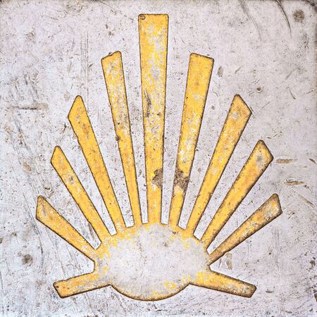 Way of St. James  - 11.09.2016 From above shot of yellow scallop shell symbol on concrete.のeditorial素材
