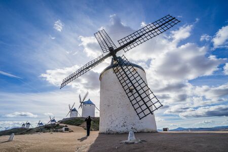 The rustic windmill placed on the background of cloudy sky in Consuegra, Ciudad Real, Spain.の写真素材