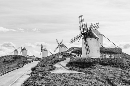 Black and white panoramic shot of rural road near the windmills in Consuegra, Ciudad Real, Spain.の写真素材