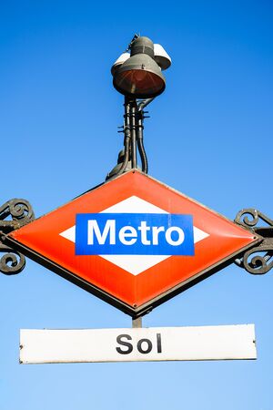 Madrid, Spain - 09.10.2016. Lozenge shape red and blue colored Metro sign.のeditorial素材