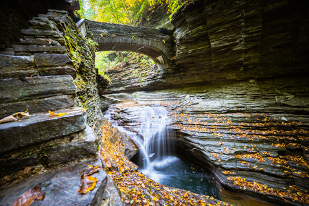 A view to small fall under bridge in gorge in Watkins Glen State Park, Finger Lakes, USAの写真素材