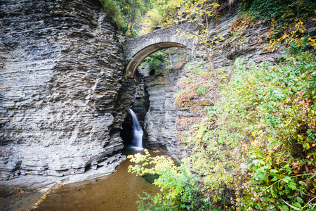 A view to small fall under bridge in gorge in Watkins Glen State Park, Finger Lakes, USAの写真素材