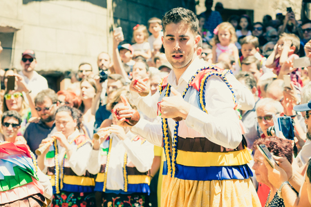 LA RIOJA,SPAIN - 23 JULY,2017:Crowd of people watching four men in bright festival costumes in the street.Anguiano festivalのeditorial素材