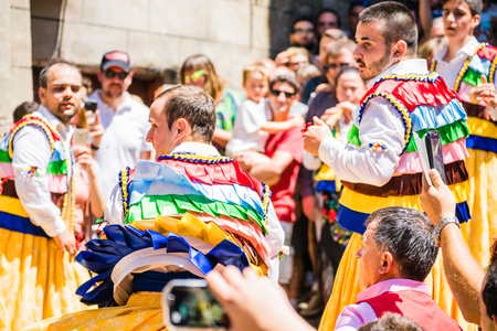 LA RIOJA,SPAIN - 23 JULY,2017:Crowd of people watching four men in bright festival costumes in the street.Anguiano festivalのeditorial素材