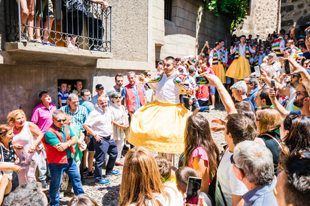LA RIOJA,SPAIN - 23 JULY,2017:Crowd of people watching four men in bright festival costumes in the street.Anguiano festivalのeditorial素材