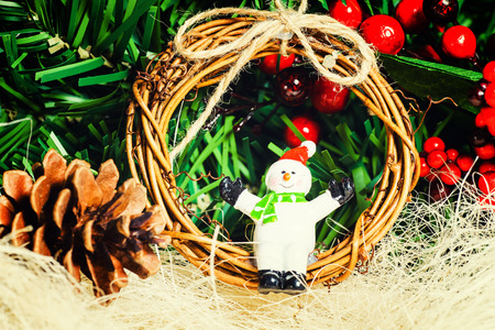 Close up of festive snowman and twig wreath and other Christmas decorations. の写真素材