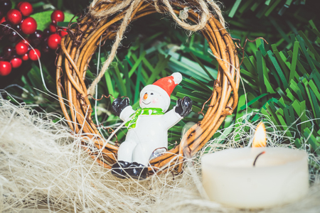 Close up of festive snowman and twig wreath and other Christmas decorations. の写真素材