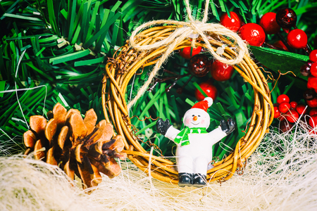 Close up of festive snowman and twig wreath and other Christmas decorations. の写真素材
