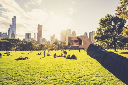 Central Park, New York, USA - 23 October, 2016: people laying on green grass.のeditorial素材
