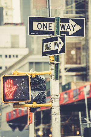New York, USA - 22 October, 2016: close up of road signs and red traffic light.のeditorial素材