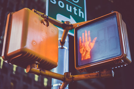 Semaphore for pedestrians showing stop sign on dark street. の写真素材