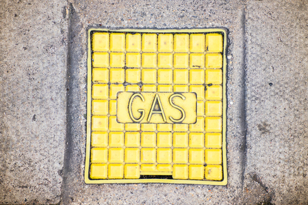 The yellow colored manhole with the gas word from below.の写真素材