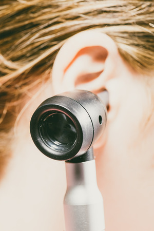 Horizontal shot of a person using an otoscope for medical inspection. の写真素材
