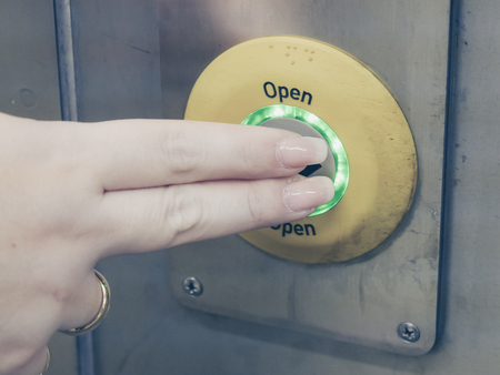 woman pushing open button