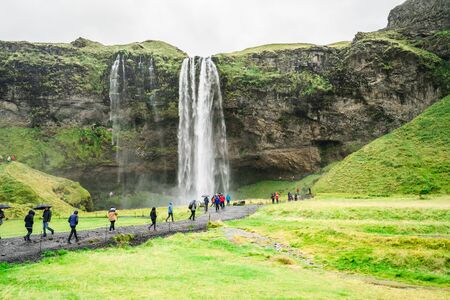 SELJALANDSFOSS, ICELAND  September 12, 2017: Tourists in Falling water at Seljalandsfoss.のeditorial素材