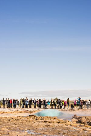 GEYSIR PARK, ICELAND  September 11, 2017: Tourists watching the Strokkur geyser erupting.のeditorial素材