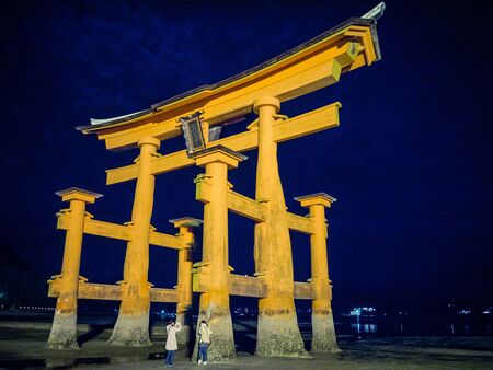 MIYAJIMA, JAPAN - MARCH 27: Sacred torii and Itsukushima Shrine at March 27, 2015 in Miyajima, Japan. Miyajima is a shinto holy site and listed in the World heritage of UNESCO.のeditorial素材