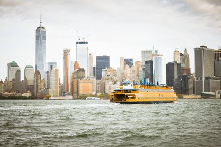 New York, USA - 20 October, 2016: Cityscape with skyscrapers and sea taxi seen from water.のeditorial素材