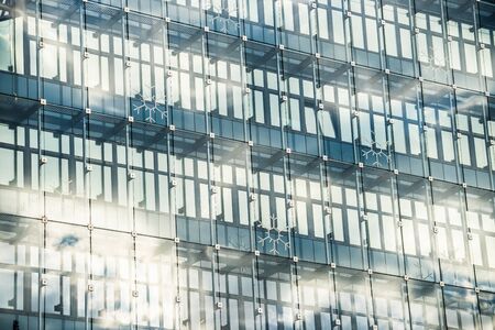Front view of skyscraper windows on sunny day.
