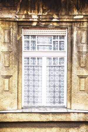 The white curtains on the window of an abandoned building. の写真素材