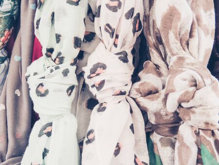 Hanging scarfs in a shopの写真素材