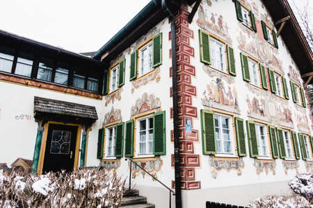 OBERAMMERGAU, GERMANY - MARCH 07: View on beautiful decorated house facade with ornamental balcony and windows on March 07, 2016 in Oberammergau, Germany.のeditorial素材