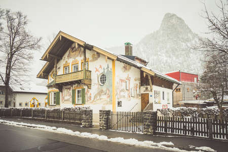 OBERAMMERGAU, GERMANY - MARCH 07: View on beautiful decorated house facade with ornamental balcony and windows on March 07, 2016 in Oberammergau, Germany.のeditorial素材
