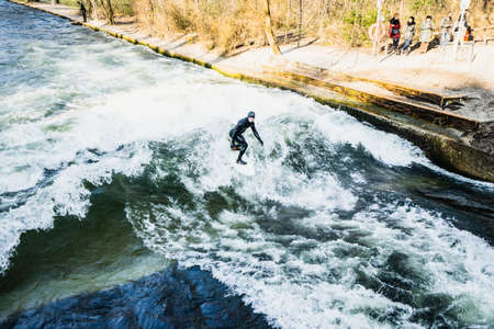 MUNICH, GERMANY - 14 MARCH 2016: Unrecognizable person surfing on artificial waves in Englischer...