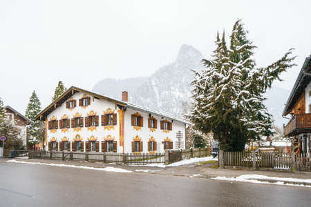 OBERAMMERGAU, GERMANY - MARCH 07: View on beautiful decorated house facade with ornamental balcony and windows on March 07, 2016 in Oberammergau, Germany.のeditorial素材