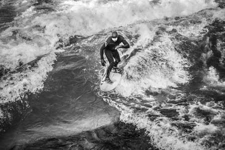 MUNICH, GERMANY - 14 MARCH 2016: Unrecognizable person surfing on artificial waves in Englischer...