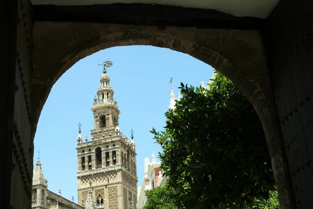 Giralda Cathedral through an arch, Andalusia, Spain.の写真素材
