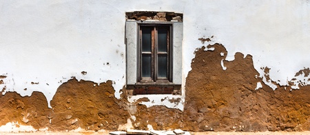 Old window and wall in Tavira, Portugalの写真素材