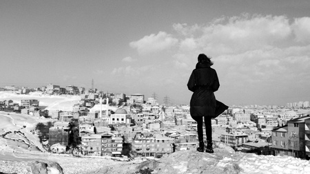 Female person watches houses  - Black and whiteの写真素材