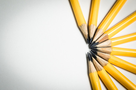 A group of yellow pencils aiming to one direction as a conceptual image of team, leadership, competition.の写真素材