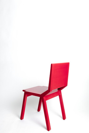 Single red modern chair in a white isolated backgroundの写真素材
