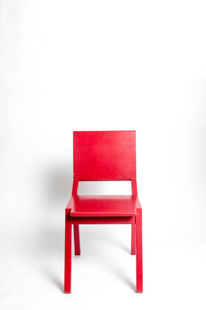 Single red modern chair in a white isolated backgroundの写真素材