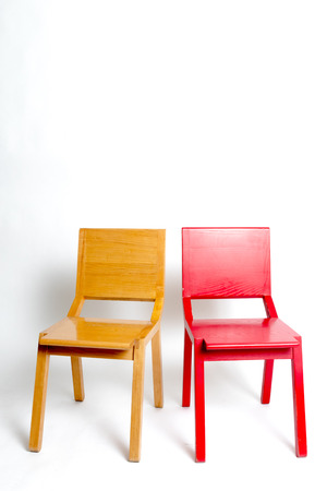 two modern chairs next to the other in a white isolated backgroundの写真素材