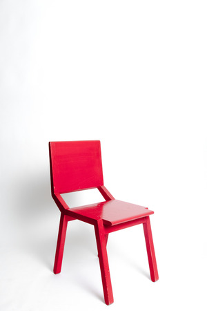 Single red modern chair in a white isolated backgroundの写真素材