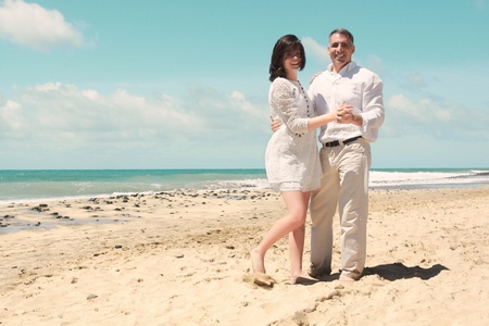 Couple looking at camera in dancing position at the beachの写真素材