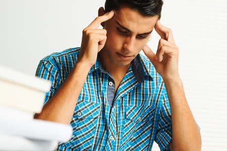 Young man concentrating while studying.