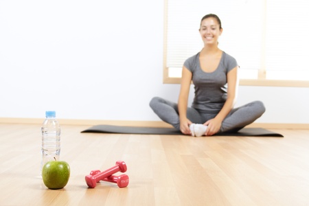Elements of a healthy lifestyle with beautiful girl doing sport in the backgroundの写真素材