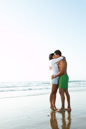 portrait of an adorable  couple in love kissing and embracing each other on the edge of the beach adorable  couple in love kissing and embracing each other on the edge of the beachの写真素材