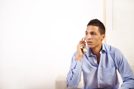 Portrait of a young businessman talking on the phone.の写真素材