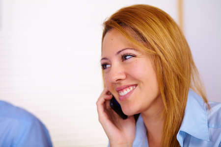 Portrait of a young business woman talking on mobile phone.の写真素材