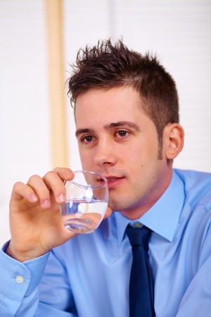 Portrait of a tired young business man.の写真素材