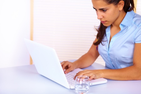 Portrait of a pretty business young woman using a laptop.の写真素材
