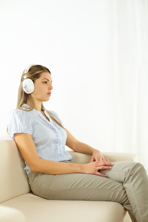 Portrait of a young cute woman listening to quiet music の写真素材
