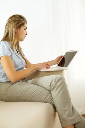 Portrait of a young woman using a laptop の写真素材