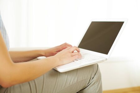 Close up portrait of the hands of a girl working with a laptop の写真素材